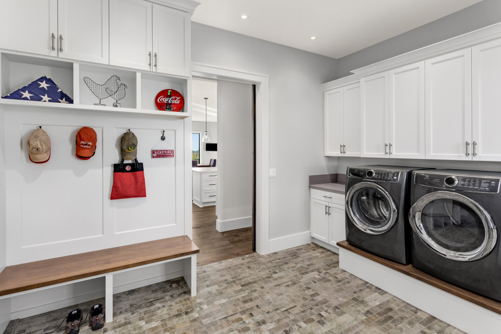 Inspiration for a transitional l-shaped utility room in Portland with shaker cabinets, white cabinets, grey walls, a side-by-side washer and dryer, multi-coloured floor and grey benchtop.