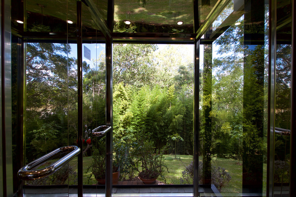Inspiration for a mid-sized contemporary foyer in Brisbane with green floor.