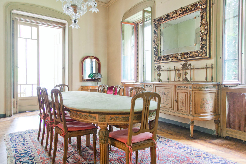 This is an example of a traditional separate dining room in Milan with medium hardwood floors.