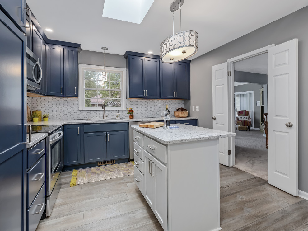 Kitchen - large transitional l-shaped kitchen idea in Raleigh with an undermount sink, recessed-panel cabinets, quartz countertops, porcelain backsplash, stainless steel appliances and an island