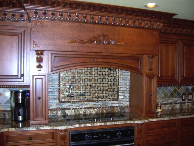 Large open concept kitchen photo in Chicago with granite countertops, raised-panel cabinets, medium tone wood cabinets, green backsplash and matchstick tile backsplash