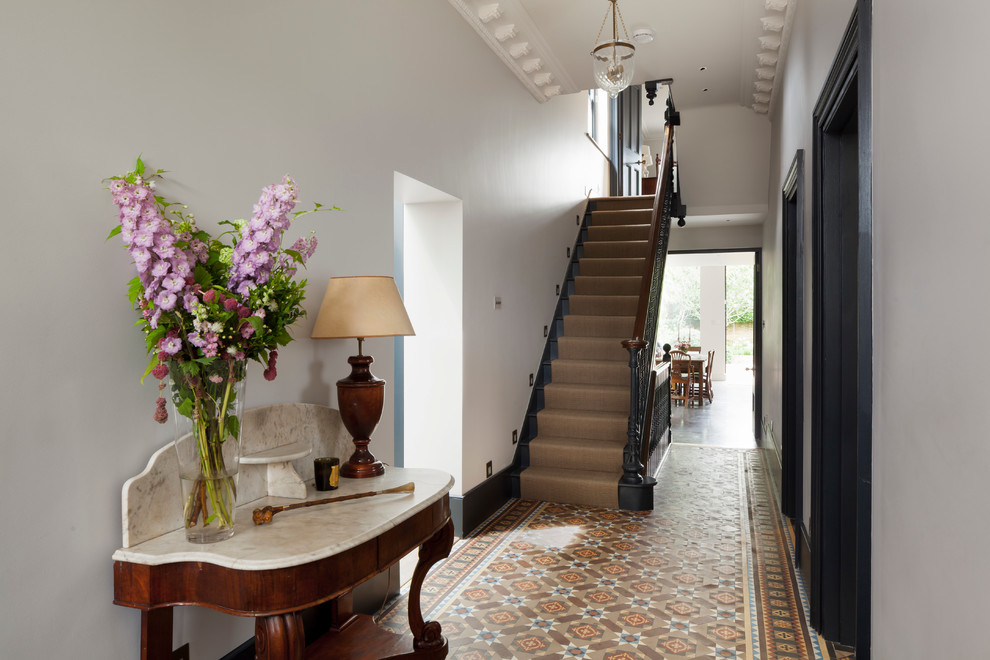Inspiration for a traditional entryway in London with white walls and multi-coloured floor.