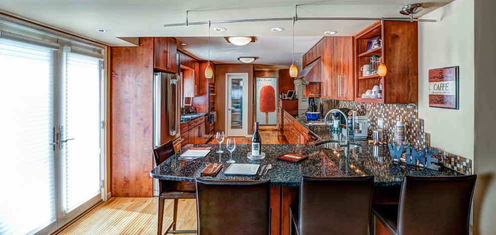 Eat-in kitchen - large transitional l-shaped light wood floor eat-in kitchen idea in Indianapolis with a drop-in sink, flat-panel cabinets, medium tone wood cabinets, multicolored backsplash, stainless steel appliances and no island
