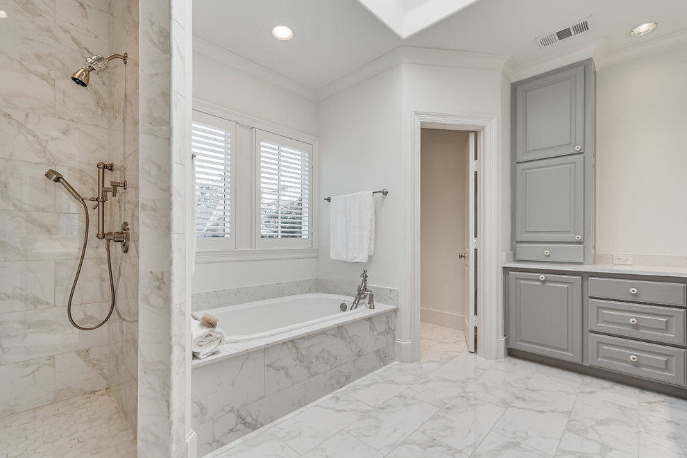 Design ideas for an expansive modern master bathroom in Dallas with grey cabinets, a drop-in tub, a corner shower, white walls, multi-coloured floor, a hinged shower door, raised-panel cabinets, a two-piece toilet, white tile, porcelain tile, porcelain floors, an undermount sink, quartzite benchtops and white benchtops.