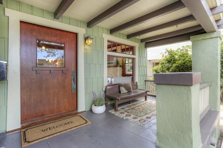 Mid-sized arts and crafts front yard verandah in Los Angeles with concrete pavers and a roof extension.
