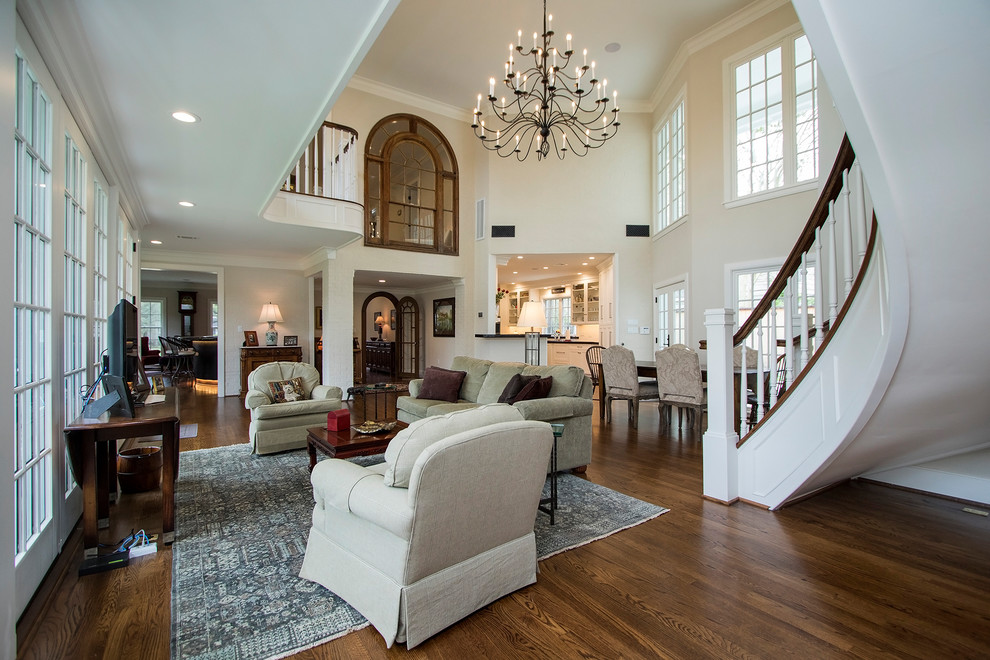 Inspiration for an expansive transitional open concept family room in Houston with white walls and dark hardwood floors.