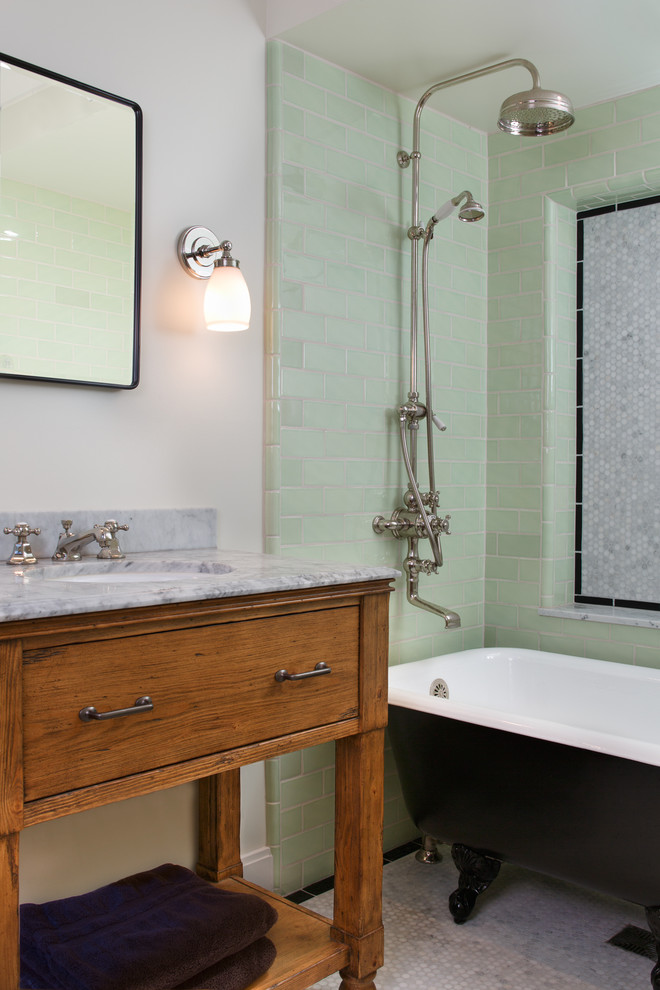 Inspiration for a traditional bathroom in San Francisco with an undermount sink, furniture-like cabinets, medium wood cabinets, marble benchtops, a claw-foot tub, green tile, subway tile and a shower/bathtub combo.