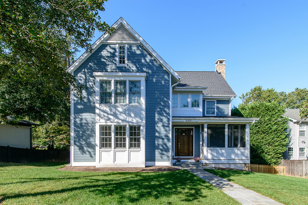 This is an example of a country three-storey blue house exterior in DC Metro with concrete fiberboard siding, a gable roof and a shingle roof.