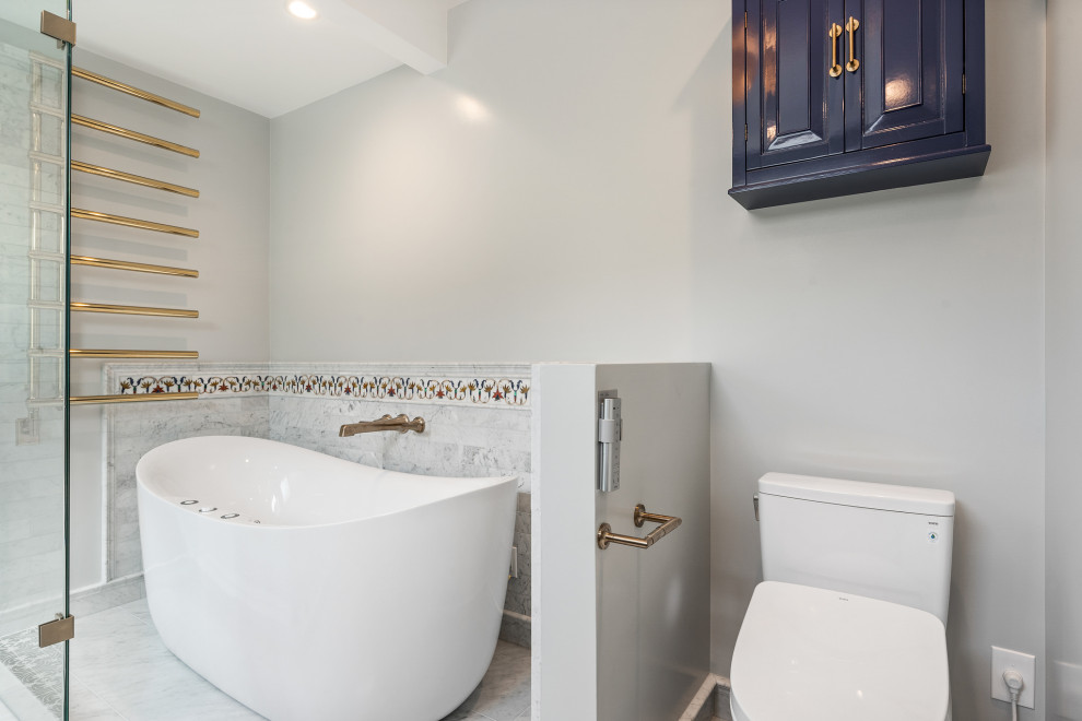 Photo of a large transitional master bathroom in San Francisco with raised-panel cabinets, blue cabinets, a freestanding tub, a corner shower, a bidet, gray tile, marble, grey walls, marble floors, an undermount sink, engineered quartz benchtops, grey floor, a hinged shower door, white benchtops, a double vanity and a built-in vanity.
