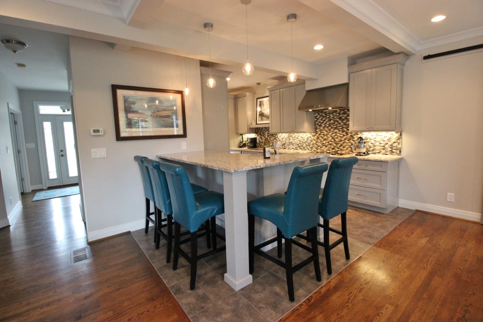 Eat-in kitchen - mid-sized transitional galley dark wood floor eat-in kitchen idea with a drop-in sink, gray cabinets, granite countertops, multicolored backsplash, stainless steel appliances and an island