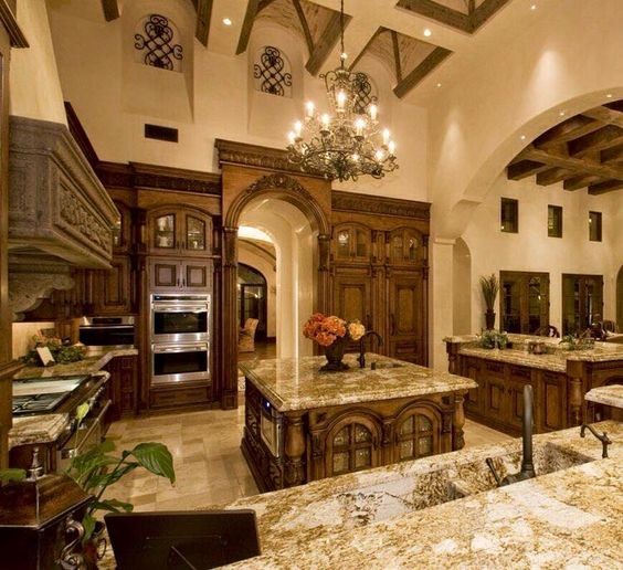 Inspiration for a rustic ceramic tile and beige floor kitchen remodel with an integrated sink, raised-panel cabinets, dark wood cabinets, beige backsplash, ceramic backsplash, stainless steel appliances and two islands