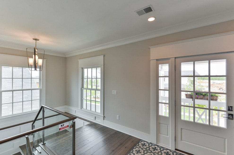 Photo of a mid-sized transitional hallway in Louisville with white walls and dark hardwood floors.