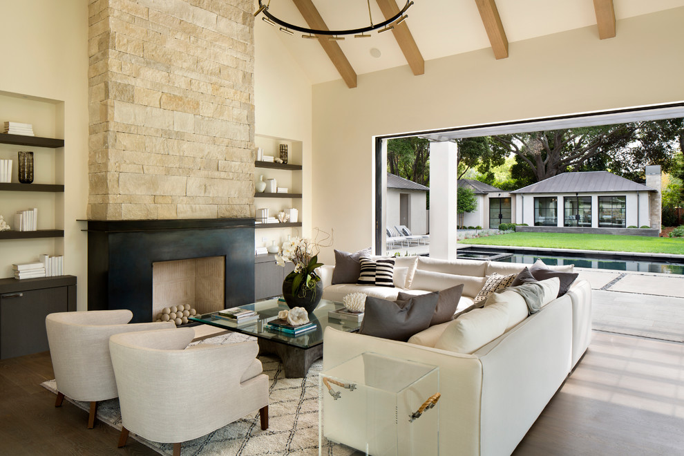 Inspiration for a modern formal open concept living room in San Francisco with concrete floors, a standard fireplace, a stone fireplace surround, no tv and beige floor.