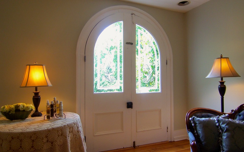 Mid-sized traditional front door in Raleigh with green walls, medium hardwood floors, a double front door, a white front door and brown floor.