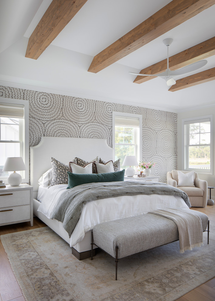 Beach style bedroom in Other with light hardwood floors and wallpaper.