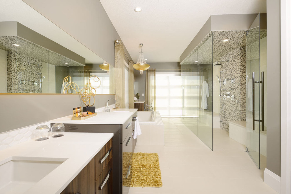 This is an example of a large contemporary master bathroom in Edmonton with flat-panel cabinets, dark wood cabinets, a drop-in tub, a curbless shower, multi-coloured tile, mosaic tile, grey walls, vinyl floors, an undermount sink and solid surface benchtops.