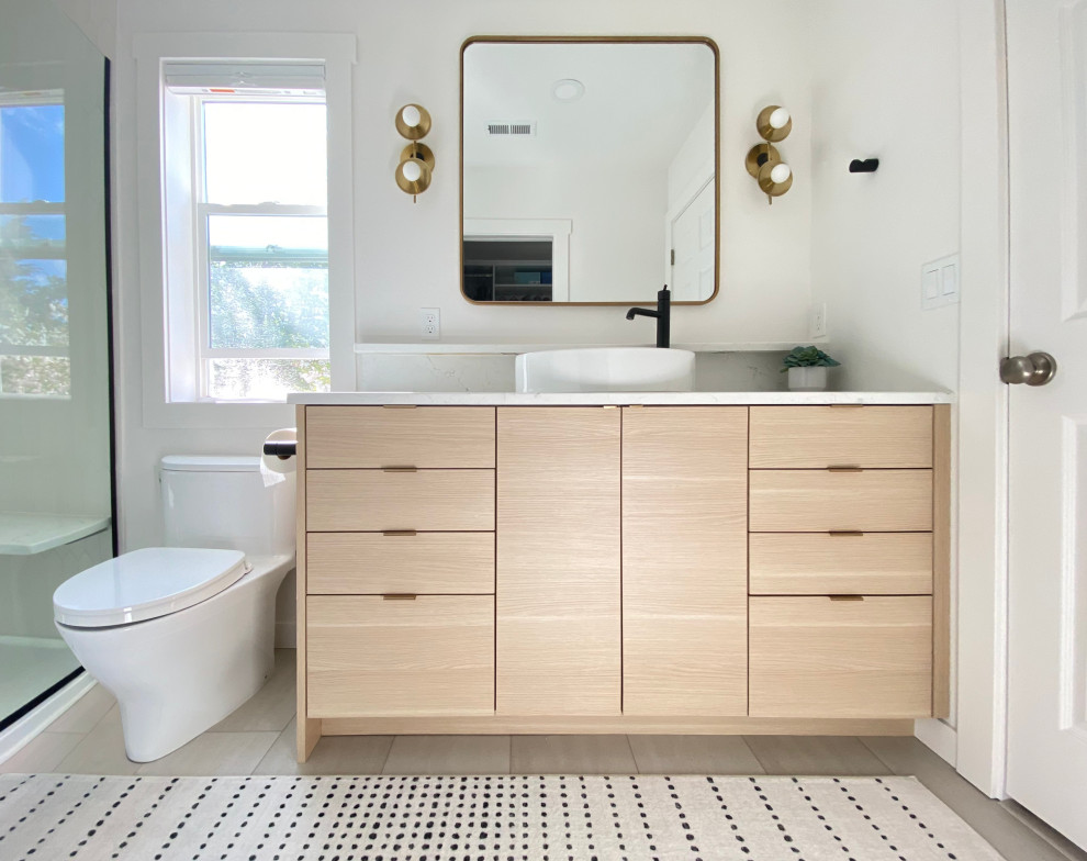 This is an example of a contemporary bathroom in Portland with flat-panel cabinets, light wood cabinets, an alcove shower, white tiles, ceramic tiles, a vessel sink, engineered stone worktops, a hinged door, white worktops, a single sink and a built in vanity unit.