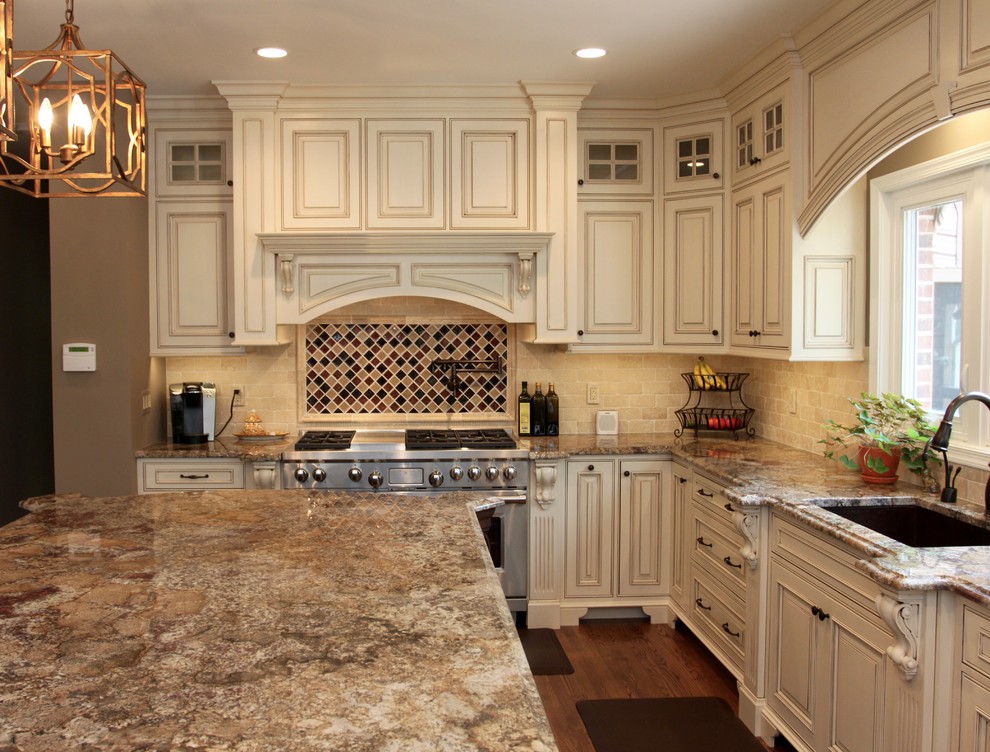 Inspiration for a large traditional l-shaped eat-in kitchen in DC Metro with an undermount sink, beaded inset cabinets, white cabinets, granite benchtops, beige splashback, stone tile splashback, panelled appliances, medium hardwood floors and with island.