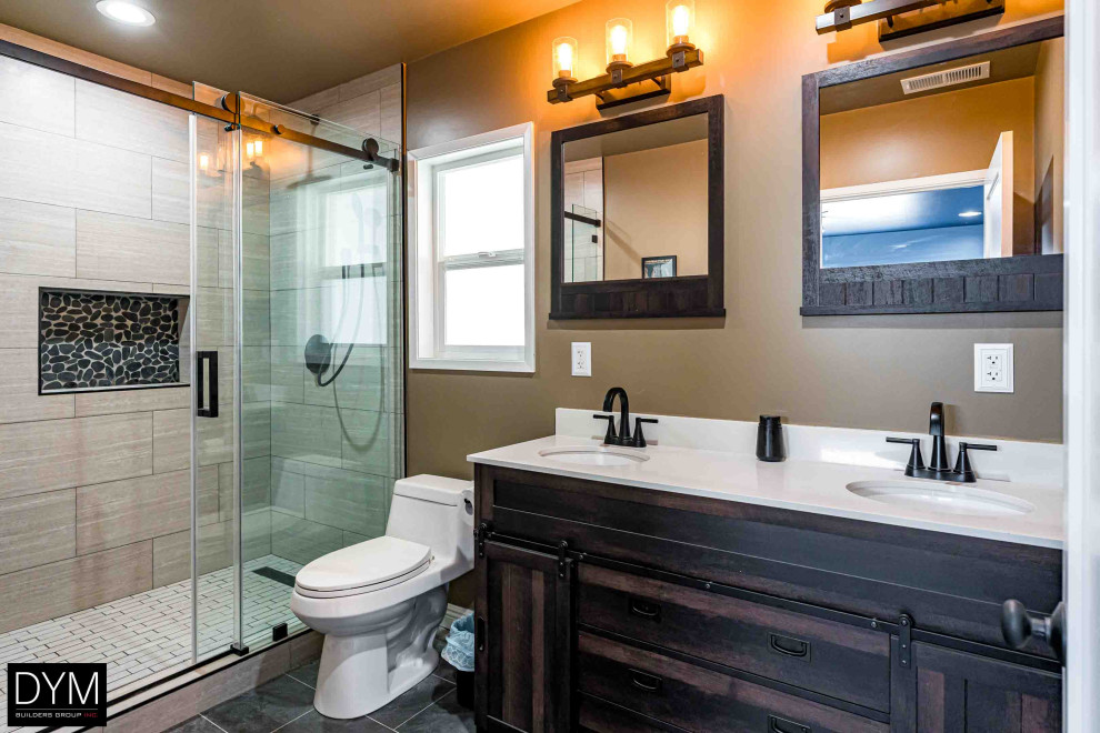 Inspiration for a mid-sized contemporary master bathroom in Orange County with furniture-like cabinets, dark wood cabinets, an alcove shower, a one-piece toilet, brown tile, wood-look tile, brown walls, cement tiles, a drop-in sink, solid surface benchtops, grey floor, a sliding shower screen, white benchtops, a double vanity, a built-in vanity, wallpaper and wallpaper.