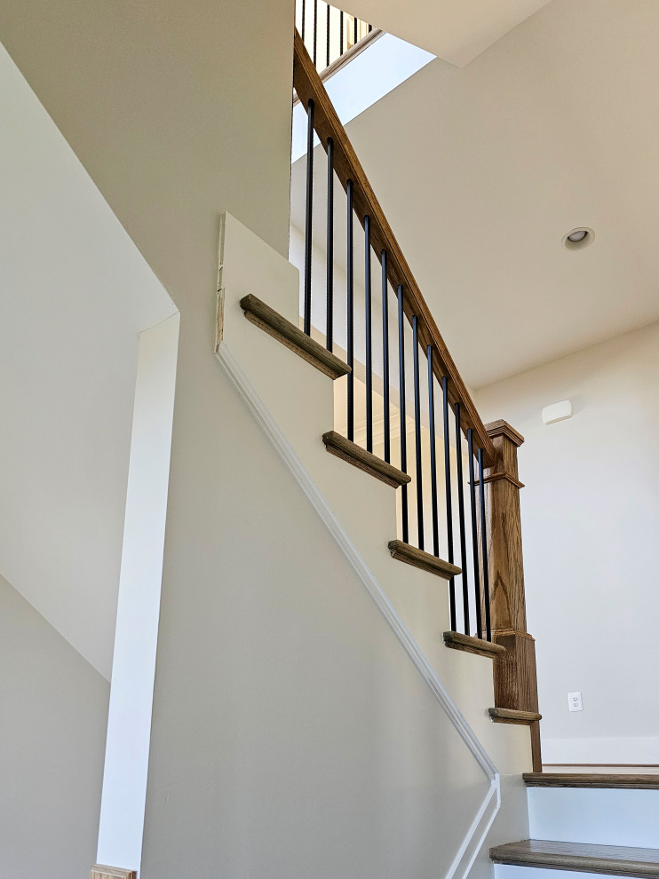 Inspiration for a small modern wood u-shaped staircase in DC Metro with wood risers and mixed railing.