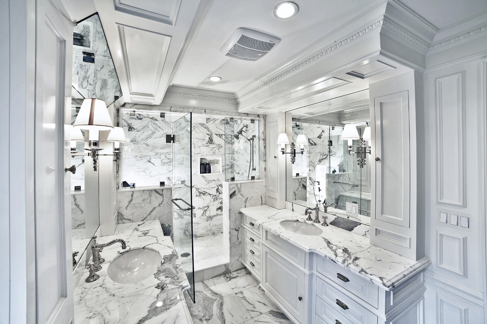 This is an example of a mid-sized traditional master bathroom in New York with beaded inset cabinets, granite benchtops, gray tile, white tile, white walls, an undermount sink, white floor, a hinged shower door, light wood cabinets, a drop-in tub, a corner shower, a wall-mount toilet, marble floors and grey benchtops.