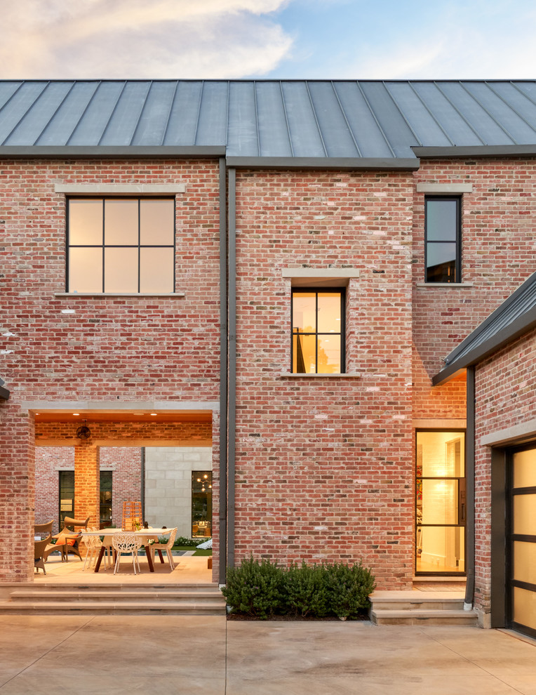 Inspiration for a large transitional two-storey brick brown house exterior in Dallas with a gable roof and a metal roof.