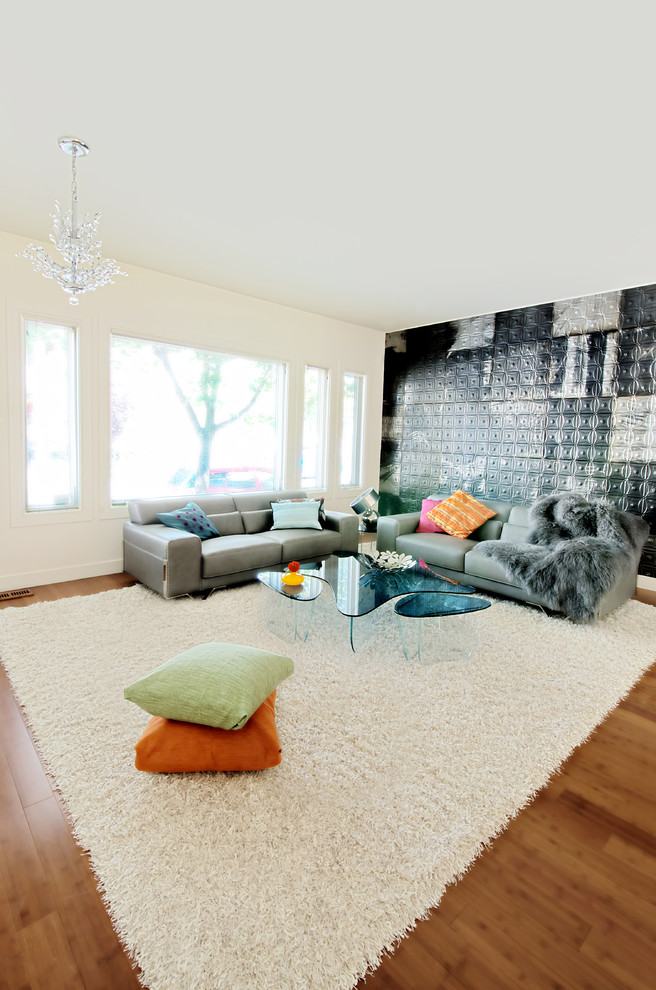 Contemporary open concept living room in Ottawa with black walls.
