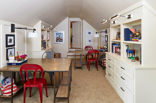 attic room with tables and chairs and storage cubbies