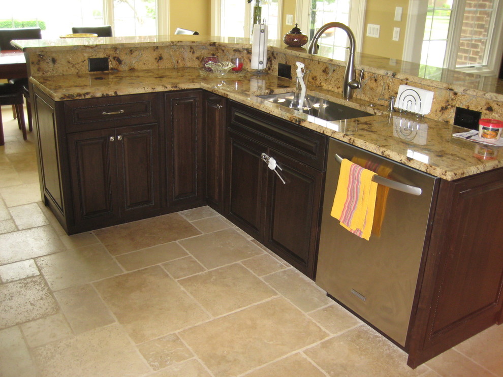 Inspiration for a mid-sized transitional l-shaped travertine floor open concept kitchen remodel in Chicago with an island, an undermount sink, raised-panel cabinets, dark wood cabinets, granite countertops and stainless steel appliances