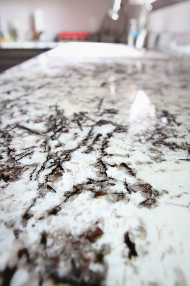 Inspiration for a large l-shaped eat-in kitchen remodel with a drop-in sink, gray cabinets, granite countertops, no island and multicolored countertops