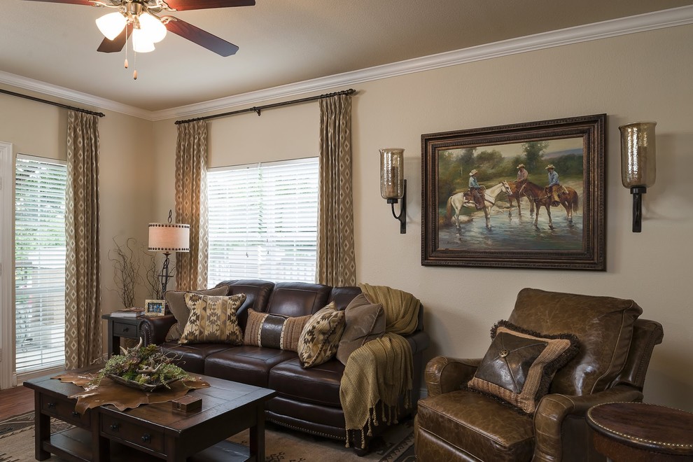 This is an example of a small open concept living room in Dallas with beige walls, medium hardwood floors and a wall-mounted tv.