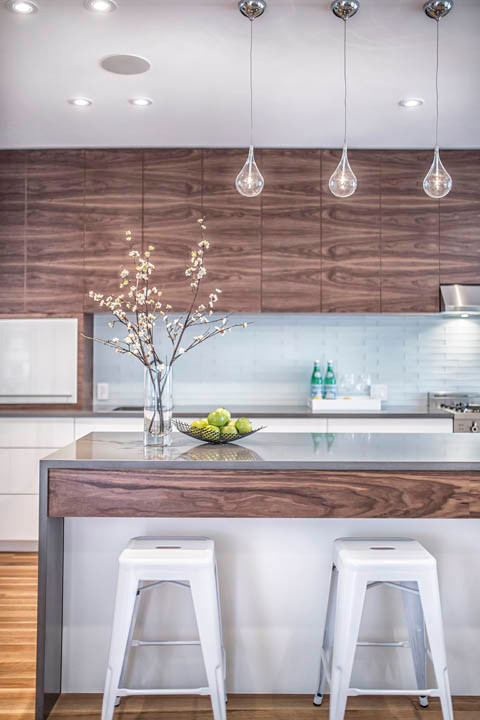 This is an example of a mid-sized contemporary l-shaped separate kitchen in Toronto with an undermount sink, flat-panel cabinets, white cabinets, concrete benchtops, blue splashback, glass tile splashback, stainless steel appliances, light hardwood floors and with island.