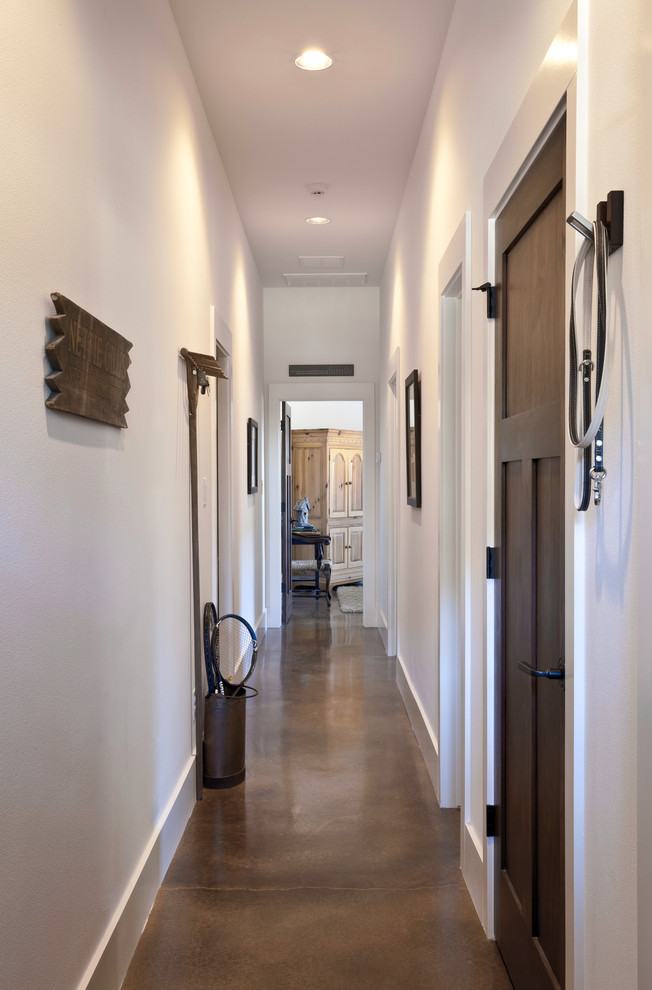 Design ideas for a small country hallway in Austin with white walls and concrete floors.
