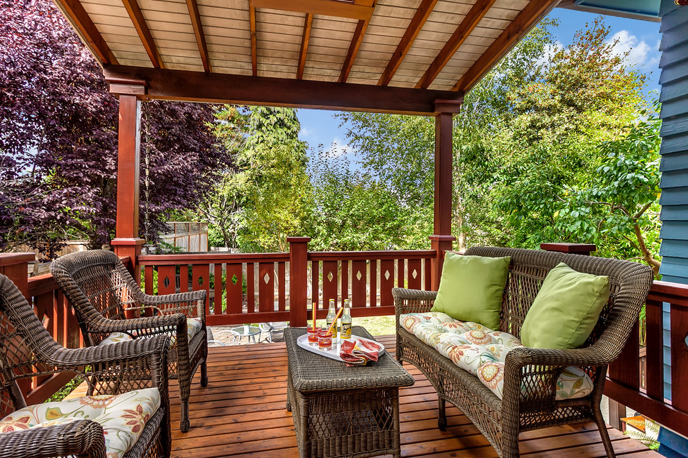 Design ideas for an arts and crafts balcony in Seattle with a roof extension and wood railing.