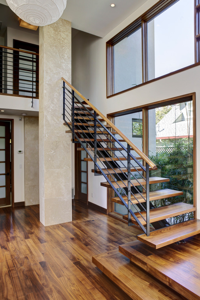 Inspiration for a mid-sized modern wood straight staircase in San Francisco with metal railing.