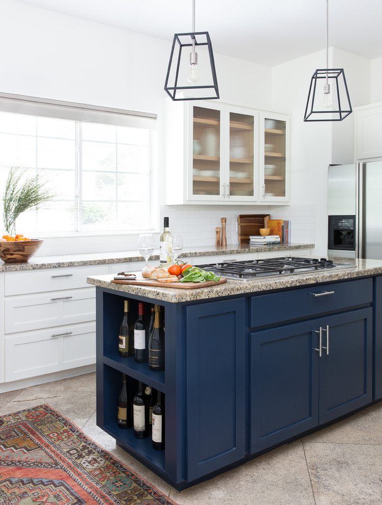 Transitional kitchen photo in Austin with glass-front cabinets, granite countertops, white backsplash, ceramic backsplash and an island