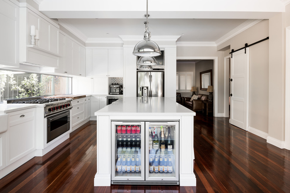 Inspiration for a mid-sized l-shaped eat-in kitchen in Perth with a single-bowl sink, shaker cabinets, white cabinets, quartz benchtops, white splashback, window splashback, stainless steel appliances, medium hardwood floors and with island.