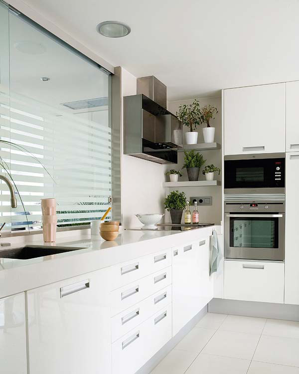 Design ideas for a mid-sized scandinavian l-shaped separate kitchen in Madrid with a single-bowl sink, flat-panel cabinets, white cabinets, stainless steel appliances, ceramic floors and no island.