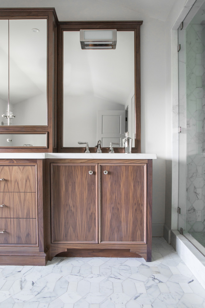 Inspiration for a mid-sized transitional master bathroom in Los Angeles with flat-panel cabinets, medium wood cabinets, a freestanding tub, an alcove shower, stone slab, white walls, marble floors, an undermount sink, quartzite benchtops, white floor and a hinged shower door.