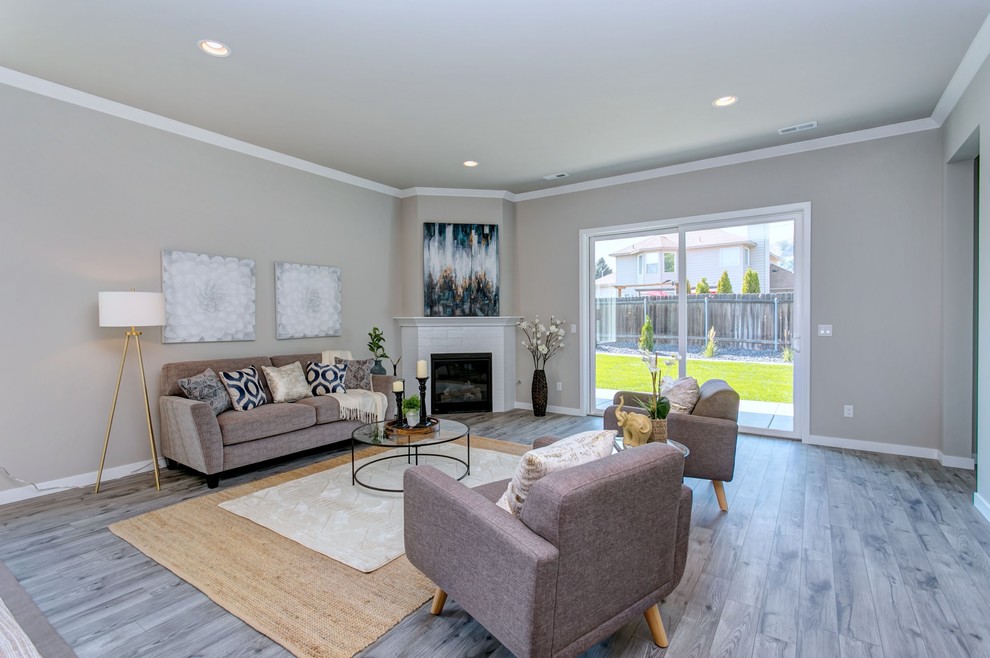 Small transitional open concept living room in Seattle with grey walls, laminate floors, a corner fireplace, a tile fireplace surround, a built-in media wall and white floor.