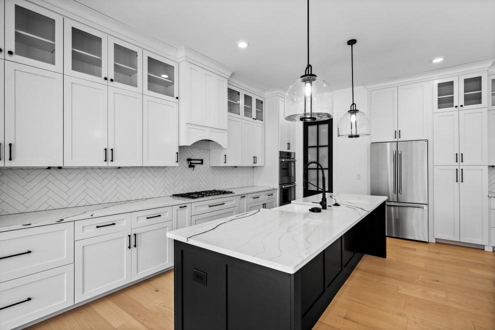 Large transitional eat-in kitchen photo in Cincinnati with a single-bowl sink, shaker cabinets, white cabinets, quartzite countertops, white backsplash, ceramic backsplash, stainless steel appliances, two islands and white countertops