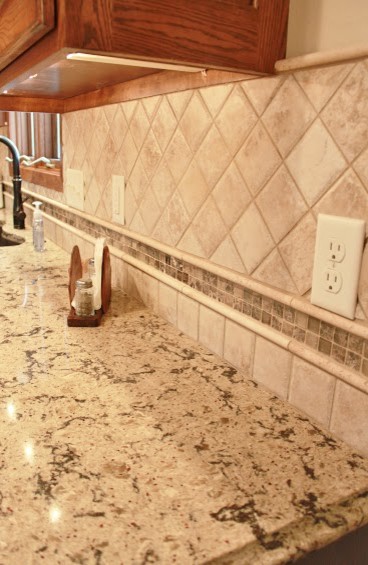 Eat-in kitchen - mid-sized modern u-shaped light wood floor eat-in kitchen idea with an undermount sink, raised-panel cabinets, medium tone wood cabinets, quartz countertops, multicolored backsplash, ceramic backsplash, stainless steel appliances and an island