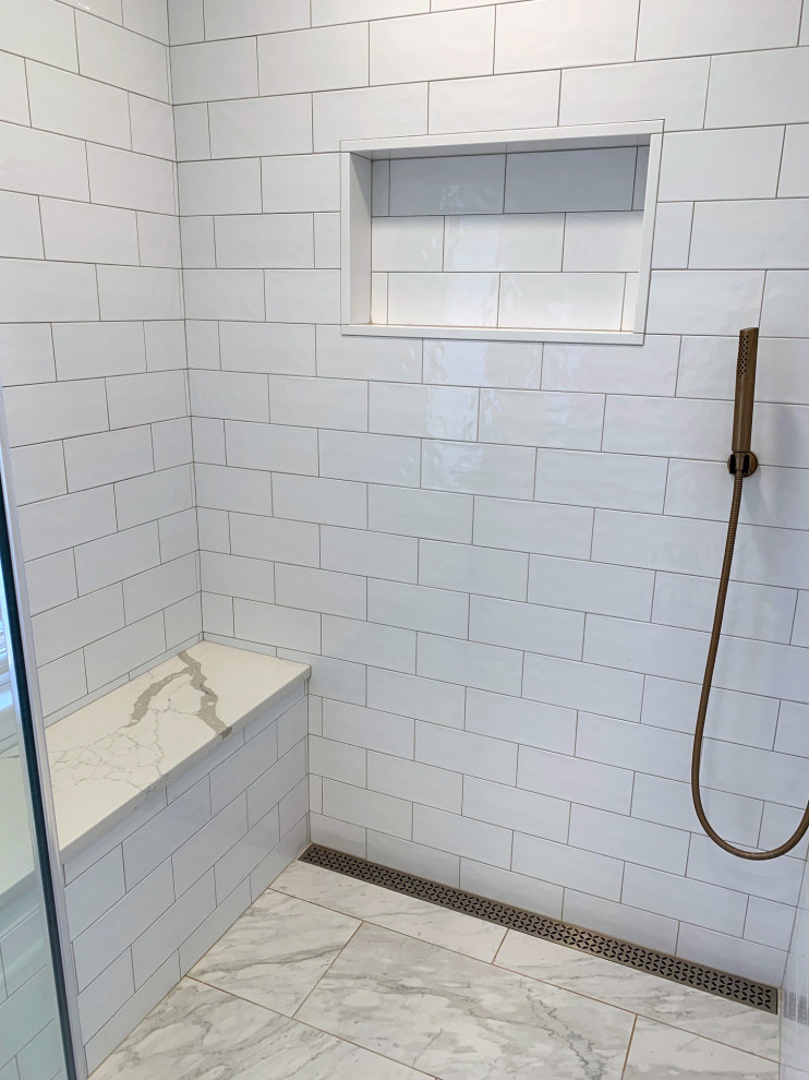 Photo of a large contemporary ensuite bathroom with an alcove shower, a one-piece toilet, blue tiles, metro tiles, blue walls, marble flooring, a submerged sink, engineered stone worktops, grey floors, a hinged door, white worktops, a shower bench, double sinks and a vaulted ceiling.