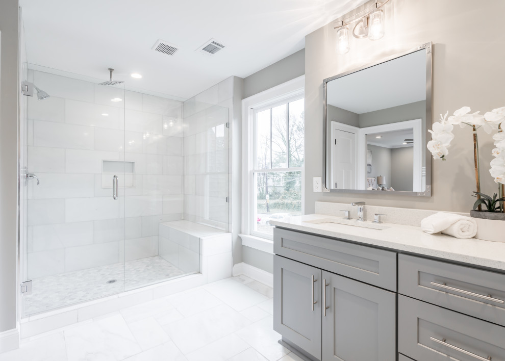Photo of a large transitional master bathroom in Atlanta with shaker cabinets, grey cabinets, an alcove shower, white tile, grey walls, porcelain floors, an undermount sink, white floor, a hinged shower door and white benchtops.