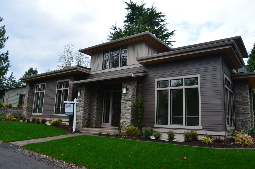 Photo of a large contemporary two-storey grey exterior in Portland with mixed siding and a hip roof.