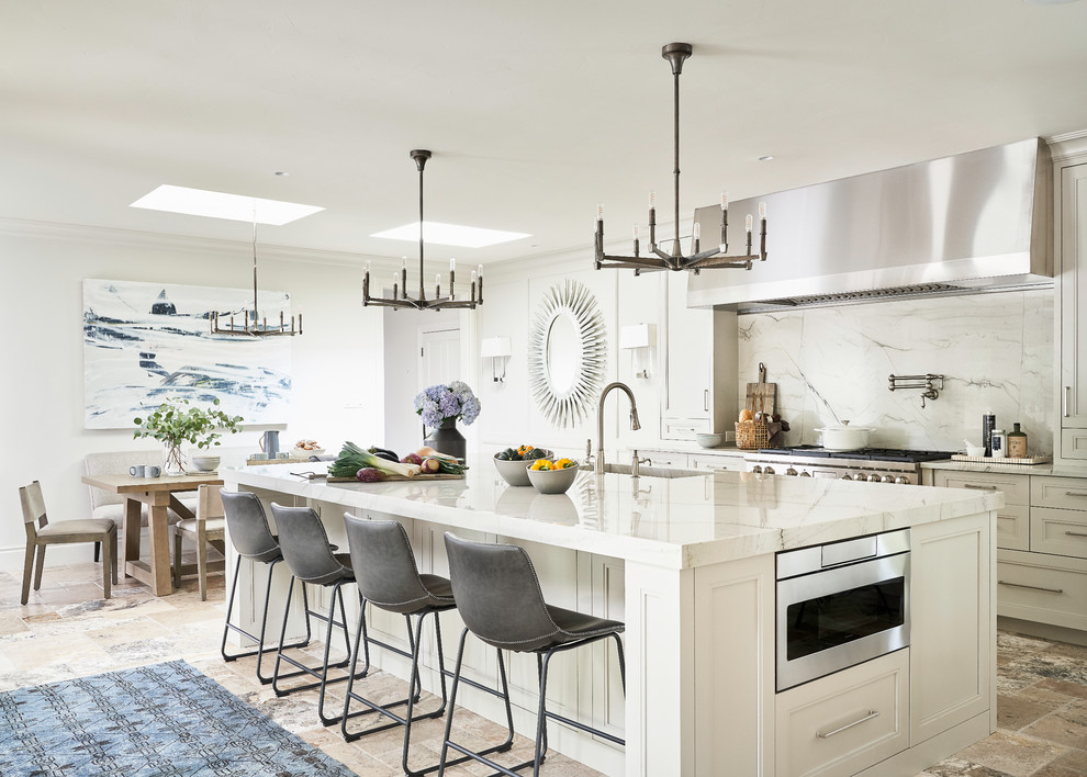 Inspiration for a large transitional l-shaped eat-in kitchen in Other with recessed-panel cabinets, grey cabinets, quartzite benchtops, white splashback, stone slab splashback, panelled appliances, travertine floors, with island, white benchtop, a single-bowl sink and beige floor.