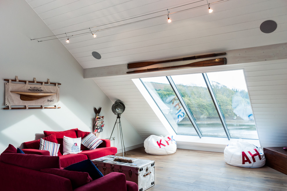 Large beach style loft-style living room in Devon with white walls, medium hardwood floors and brown floor.