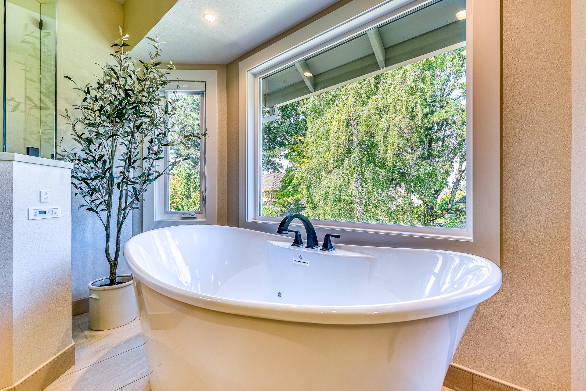 This 90's beauty had an odd layout with a built-in tub deck.  It had a closed off layout and was dated with striped wallpaper, tiled countertops and gold fixtures. We removed the tub deck and installe