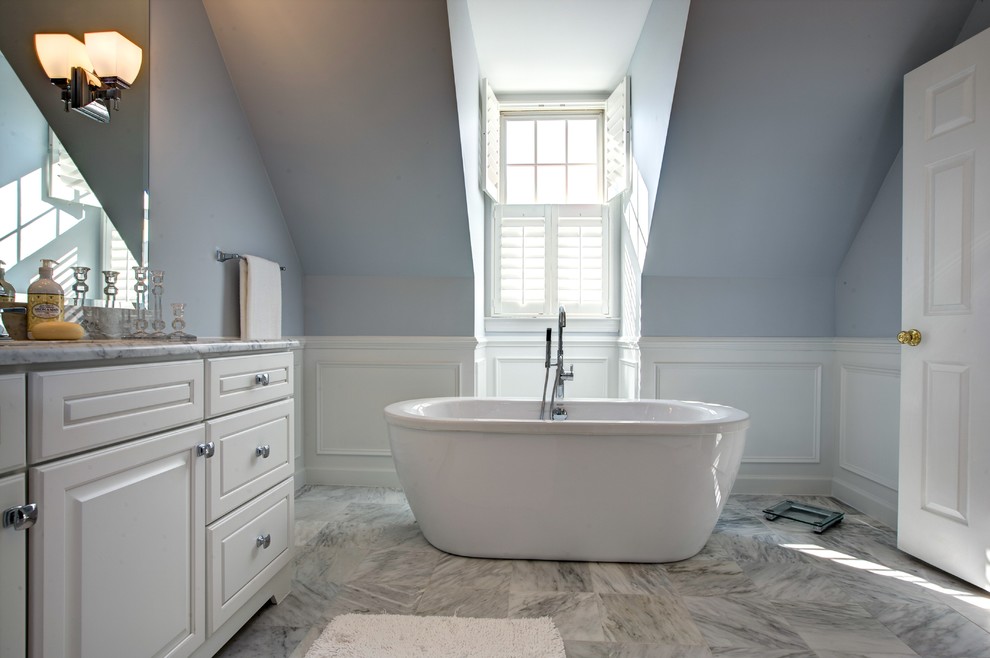 Freestanding bathtub - mid-sized transitional master white tile and marble tile marble floor freestanding bathtub idea in DC Metro with raised-panel cabinets, white cabinets, marble countertops, gray walls and an undermount sink