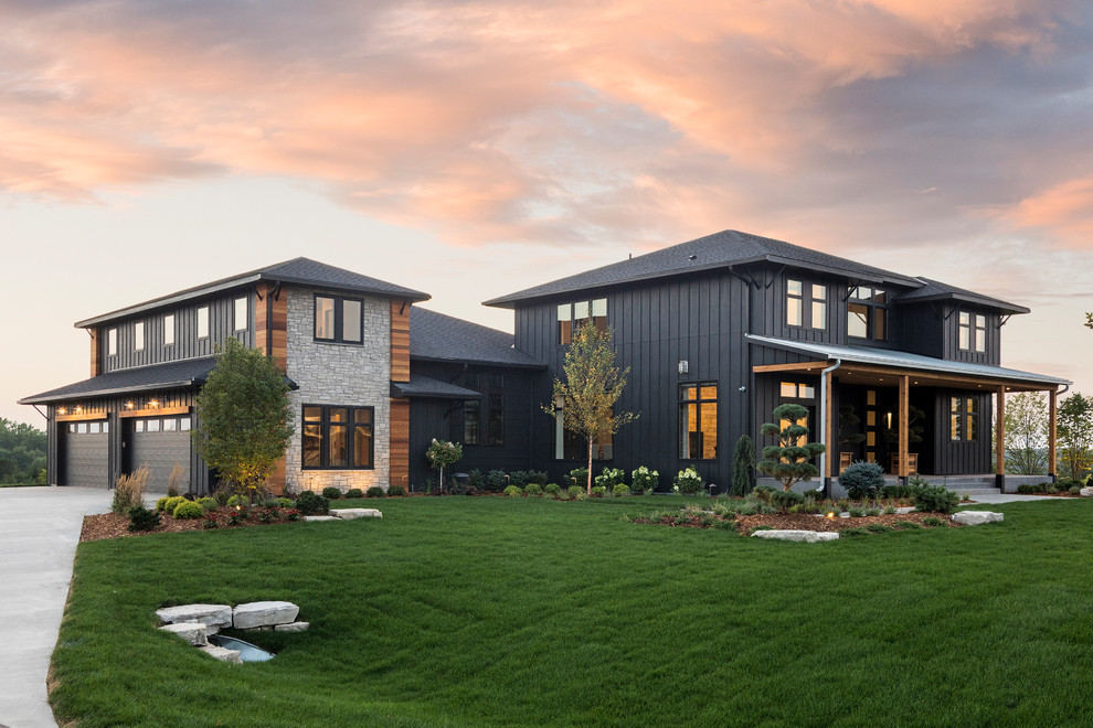 Inspiration for a contemporary two-storey black house exterior in Minneapolis with mixed siding, a hip roof and a shingle roof.